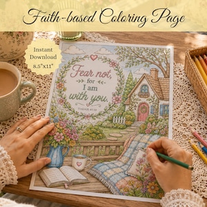 May include: A coloring page featuring a cottage scene with a floral wreath and the text Fear not, for I am with you. Isaiah 41:10. The illustration includes a house, a garden, a blanket, a book, and a mug. The page is labeled 8.5 inches by 11 inches.