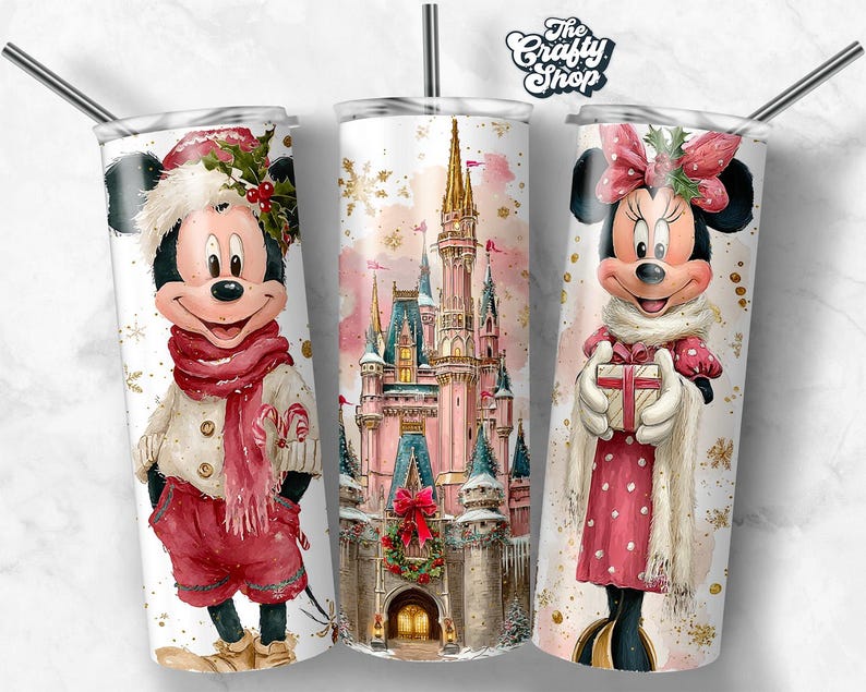 May include: Three white insulated tumblers with stainless steel straws. The tumblers feature festive watercolour designs of Mickey Mouse, Minnie Mouse, and a castle. Mickey Mouse is wearing a red scarf and shorts. Minnie Mouse is holding a gift.