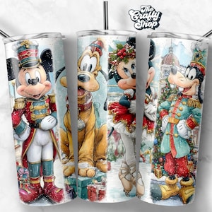 May include: Three stainless steel tumblers with a winter holiday theme. Each tumbler features a different Disney character: Mickey Mouse, Pluto, Minnie Mouse, and Goofy, all dressed in festive attire. The Crafty Shop logo is at the top.