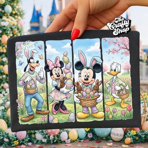 May include: Black graphic tee featuring Disney characters Goofy, Minnie Mouse, Mickey Mouse, and Donald Duck, all dressed for Easter. Each character holds Easter eggs and baskets. The tee has the text "The Crafty Shop".