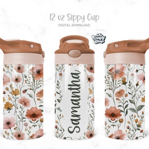 Peut inclure: Une tasse à bec de 12 oz avec un motif floral. La tasse présente un fond blanc avec un motif de fleurs roses, oranges et jaunes et de feuilles vertes. Le couvercle et le bec sont de couleur marron clair. Le nom "Samantha" est imprimé sur la tasse.