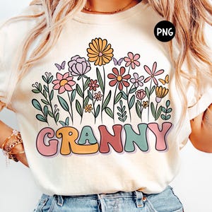 May include: A white t-shirt with a floral design and the word "Granny" in colorful, retro-style lettering.