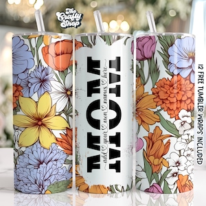 Pode incluir: Três copos de aço inoxidável com designs florais. O copo do meio é branco com texto preto que diz "TATATAT add your own names here".