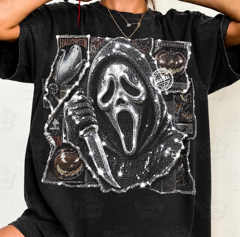 May include: A black t-shirt featuring a large, central graphic of a hooded figure with a mask holding a knife. The design includes smaller rectangular panels with Halloween-themed imagery, including pumpkins and corn, and a circular stamp reading ORIGINAL.