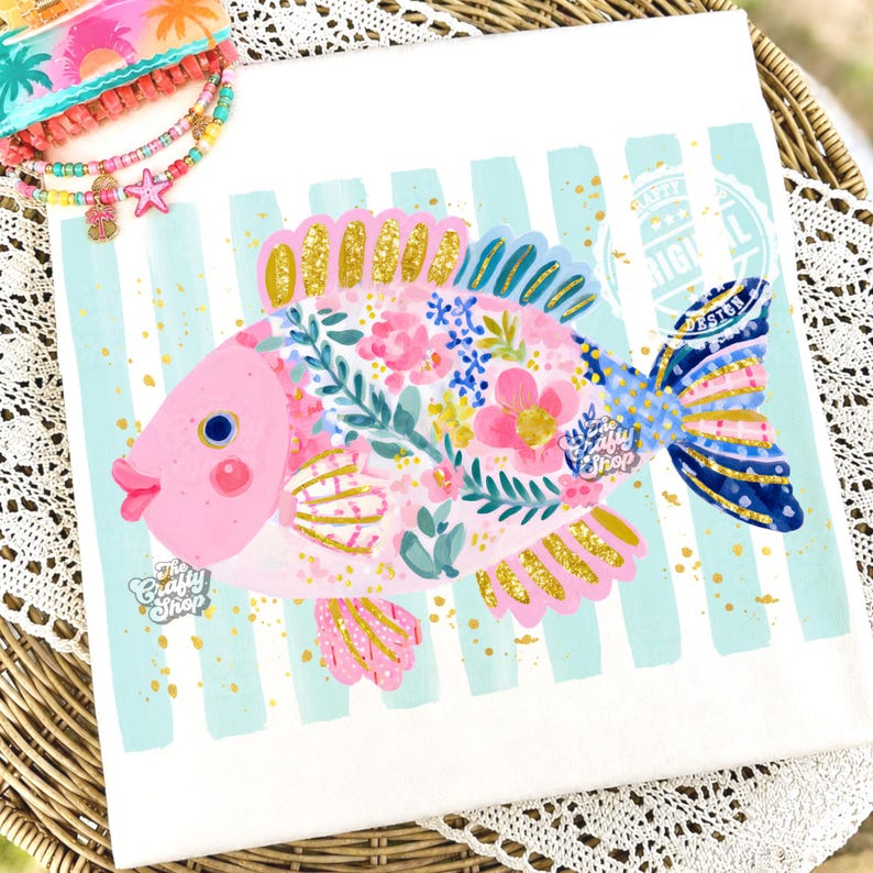 May include: A whimsical pink fish illustration with floral and gold accents. The fish is set against a backdrop of light blue stripes and gold flecks. The text "The Crafty Shop" is visible.