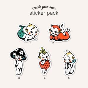 May include: A create your own sticker pack featuring five numbered illustrations of babies in various costumes: a mermaid, a red devil, a mushroom, a strawberry, and an angel with wings and a halo. Each character has a distinct vintage style.