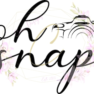 May include: Black and white illustration of a camera with the text "oh snap" in a black cursive font. The text is surrounded by a gold geometric frame and pink floral accents. The text "Designs Est 2023" is in a smaller font below the camera.