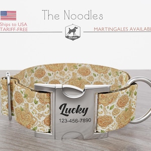 May include: A dog collar with a floral pattern in shades of beige, yellow, and green. The collar has a silver metal buckle engraved with the name "Lucky" and a phone number. The brand name "The Noodles" is visible.