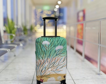 May include: A green and white suitcase with a design of sea life, including jellyfish and coral. The suitcase has black wheels and a black handle.