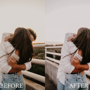 May include: A couple embrace on a bridge with a white railing. The woman is wearing a white shirt and blue jeans. The man is wearing a white shirt and blue jeans. The couple are facing away from the camera.