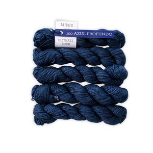May include: Five skeins of dark blue yarn are arranged vertically against a white background. A tag at the top reads "MINIS" and "150 AZUL PROFUNDO" with "ULTIMATE SOCK" below. The yarn appears soft and is tightly wound.