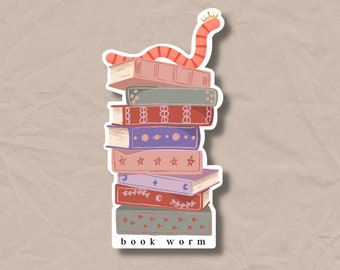 May include: A stack of colourful books with a red worm wearing a gold crown on top. The bottom book has the text "book worm" printed on it.