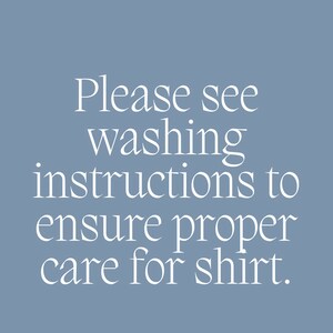 May include: A blue background with white text that reads: "Please see washing instructions to ensure proper care for shirt."