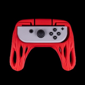 May include: Red silicone grip case for a Nintendo Switch controller. The case has a textured design and fits snugly around the controller.