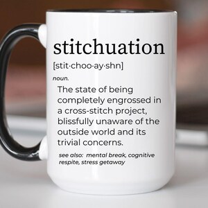 May include: White ceramic mug with a black handle and rim. The mug features the word "stitchuation" in black text, along with a definition. The definition describes being engrossed in a cross-stitch project. The mug is a perfect gift for crafters.