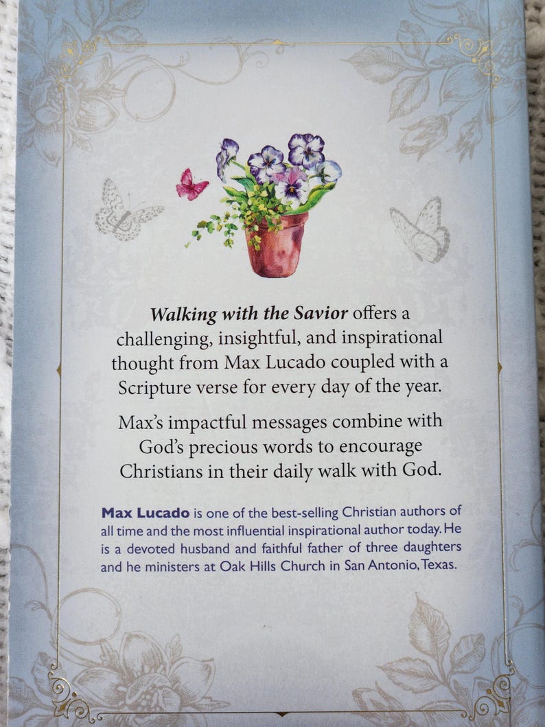May include: The back cover of a book with the title "Walking with the Savior". It features a watercolor illustration of a flower pot with purple and white flowers and butterflies. The text describes the book's content.