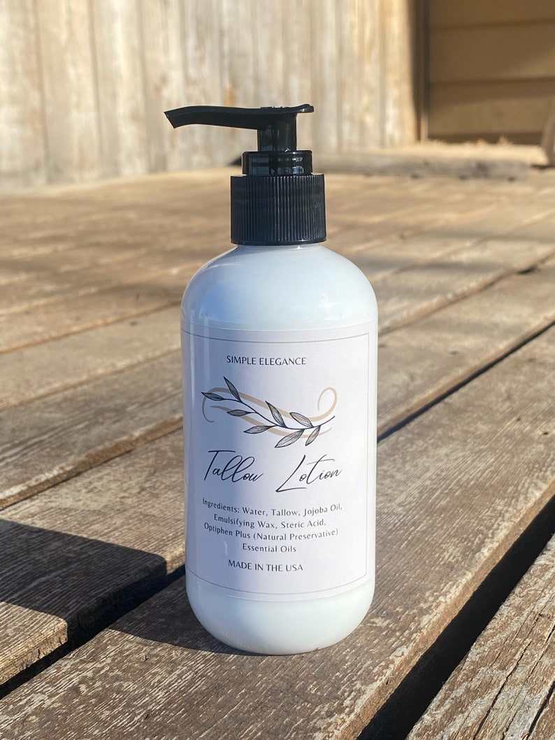 May include: White bottle of Tallow Lotion with a black pump top. The label reads "Simple Elegance" and lists the ingredients: Water, Tallow, Jojoba Oil, Emulsifying Wax, Steric Acid, Optiphen Plus (Natural Preservative), Essential Oils. The bottle also says "Made in the USA".
