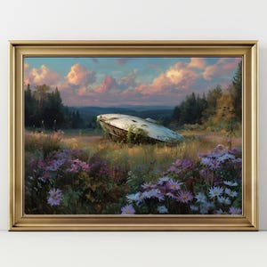 May include: A framed landscape painting depicts a crashed UFO in a field of wildflowers. The sky is filled with pink and blue clouds. The artwork is framed in a gold-colored frame.