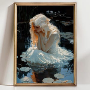 May include: Framed art print depicting a woman with long blonde hair in a white dress, seated in a pond with lily pads. The artwork has a soft, ethereal quality, with a gold frame. The water reflects the figure and the surrounding dark foliage.