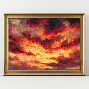 May include: An oil painting of a dramatic sunset with fiery red, orange, and yellow clouds. The artwork is framed in a gold-colored, ornate frame, enhancing the vibrant colors of the sky.