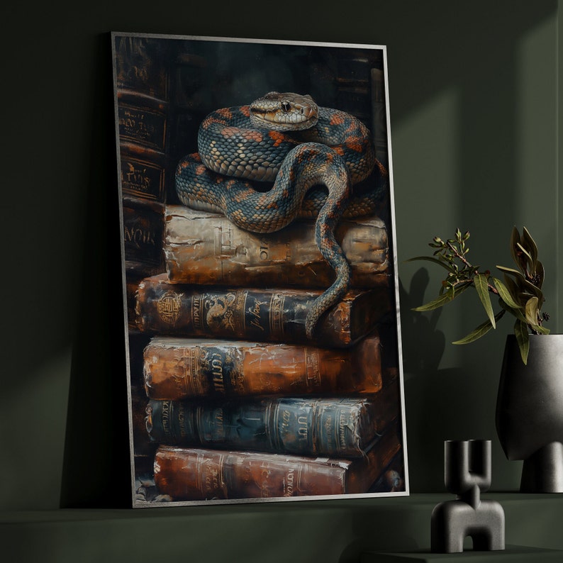 May include: A framed art print featuring a detailed illustration of a snake coiled atop a stack of antique books. The snake has a pattern of blue, orange, and black scales. The books are aged with visible wear and tear, creating a vintage aesthetic.