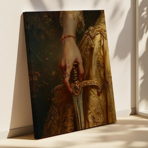May include: A canvas print of a classical painting featuring a hand holding a sword. The hand is adorned with rings and a bracelet. The person is wearing a gold dress with intricate floral patterns. The artwork has a vintage aesthetic.