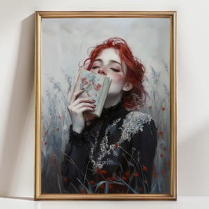 May include: A framed art print featuring a woman with red hair holding a book adorned with floral designs. She wears a black dress with white lace detailing. The background depicts a field of flowers in shades of red, white, and blue.
