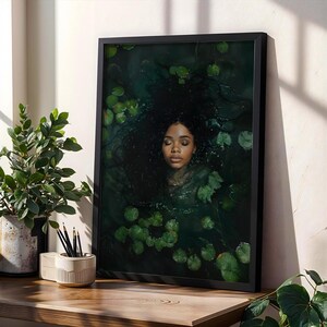 May include: A framed print of a woman with long dark hair submerged in a body of water with green lily pads. The woman's eyes are closed and she appears to be sleeping.