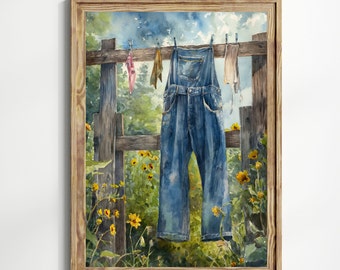 May include: Watercolor painting of blue denim overalls hanging on a clothesline over a wooden fence. The scene includes yellow sunflowers and a blue sky, creating a rustic, country aesthetic. The artwork is framed in a natural wood frame.