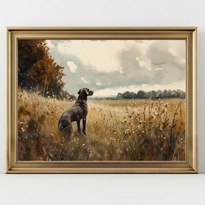 May include: A framed watercolor painting of a brown dog standing in a field of tall grass. The dog is looking off to the side, and the sky is cloudy. The painting is framed in a gold frame.