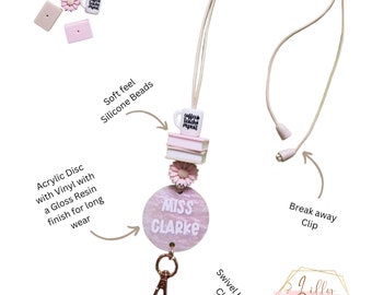 May include: Pink and white teacher ID badge lanyard with a coffee cup charm, a stack of books, a flower charm, and a round acrylic name tag that says "Miss Clarke". The lanyard has a swivel hook clasp and a breakaway clip.