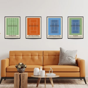 May include: Four minimalist posters with a tennis court design in different colors. The posters are framed in black and have the names of the Grand Slam tournaments: Wimbledon, Roland Garros, Australian Open, and US Open.