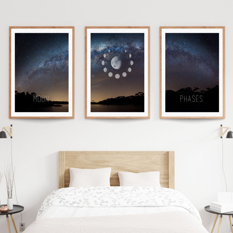May include: Three framed art prints featuring night sky scenes. The left print has the word "MOON" at the bottom. The center print shows the phases of the moon. The right print has the word "PHASES" at the bottom. All prints have a wooden frame.