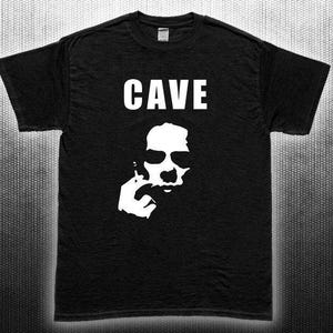 May include: Black t-shirt with the word "CAVE" in bold white letters at the top. Below the word is a white graphic of a face with sunglasses and a hand near the mouth. The shirt is made of a soft material.