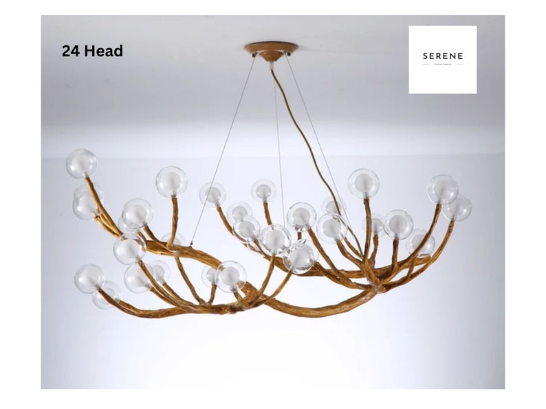 May include: A 24-head chandelier with a unique branch-like design and clear glass globes. The chandelier is made of wood and has a gold finish.