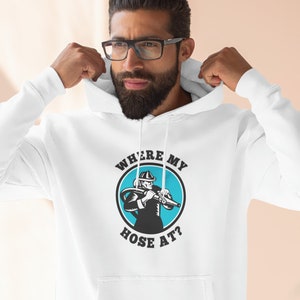 May include: White hoodie with a blue circle graphic featuring a firefighter holding a hose and the text "Where's my hose at?"