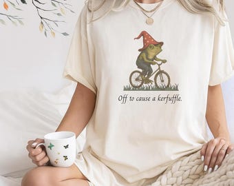 Whimsical Wizard Frog Shirt, Off to Cause a Kerfuffle T-Shirt, Funny Surreal Cottagecore Graphic Tee, Weirdcore Aesthetic Frog on Bike Top