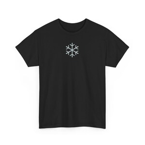 May include: Black t-shirt with a silver snowflake graphic on the front.