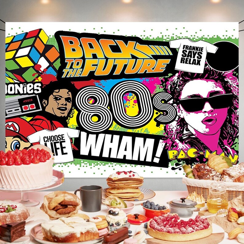 May include: A colorful 80s themed party backdrop with the text "Back to the Future" and "Wham!"  The backdrop also features images of a Rubik's Cube, a video game controller, a cassette tape, a microphone, and a Pac-Man character.
