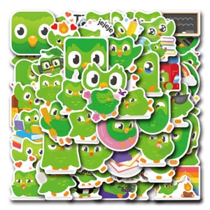 May include: A collection of colourful stickers featuring a green owl with various expressions and poses. The stickers include the text "jejeje" and a schoolhouse with a chalkboard.