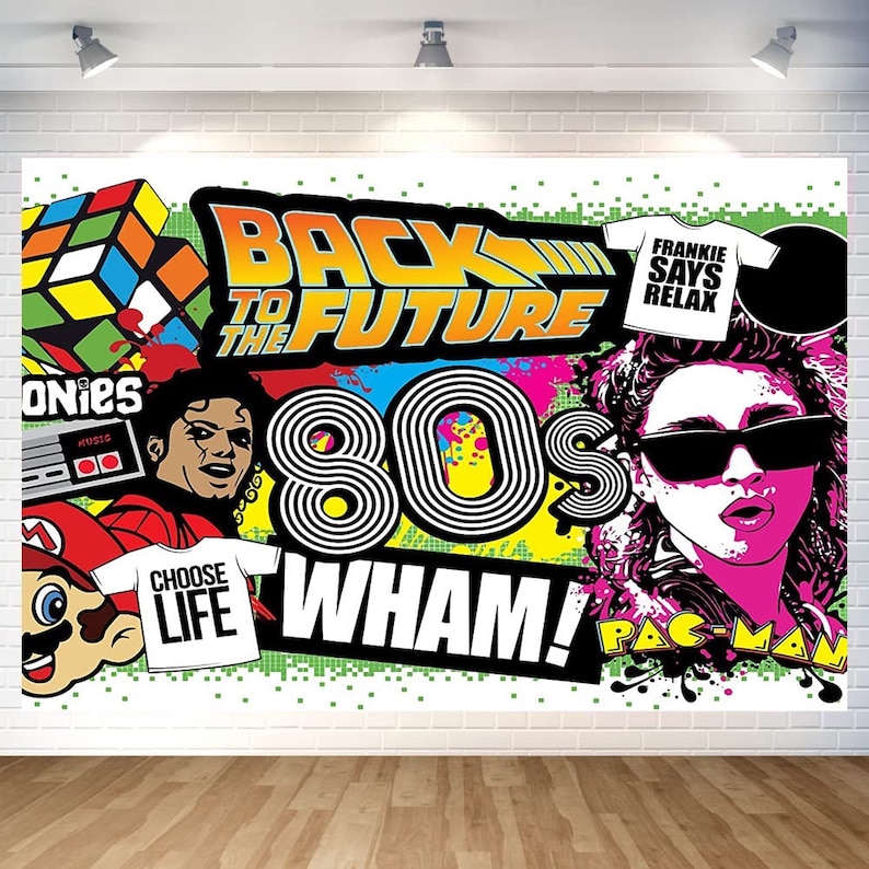 May include: A colorful 80s themed party backdrop with the text "Back to the Future", "80s", "Wham!" and "Pac-Man".  The backdrop also features images of a Rubik's Cube, a video game controller, a cartoon character, and a person wearing sunglasses.