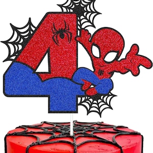 May include: A red and blue glitter cake topper featuring the number 4 and a Spider-Man figure. The number 4 is red with a black spider graphic, and the figure is in a classic pose. Black spiderwebs are on the top.