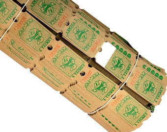 May include: A roll of brown paper tickets with green text and a Pac-Man character. The tickets are tied together with a white string. The text on the tickets reads "1 TICKET" and "PAC-MAN".