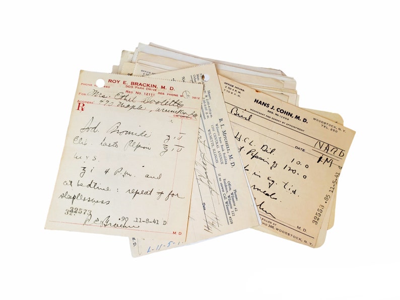 May include: A stack of vintage medical prescription forms with handwritten notes. The top form is from Hans J. Cohn, M.D. in Woodstock, NY. The form has a date of 11/2/1926 and a prescription for H.C.L. Dil 100, 1. Pepsin 7s 120.0, and Bing. tid. med.
