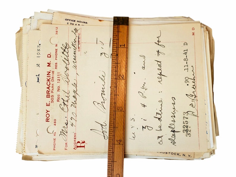 May include: A stack of old medical prescription forms with handwritten notes. The top form is for "Mrs. Ethel Doolittes" and includes the text "Lod. Bromide" and "cit bedtive: repeat of for slaplesswss".