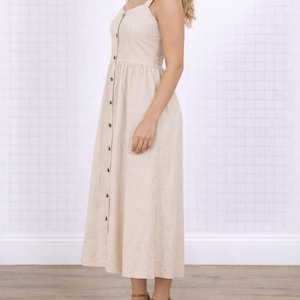 Side view of woman wearing a beige Button Down Sweetheart Long Dress on a white background.