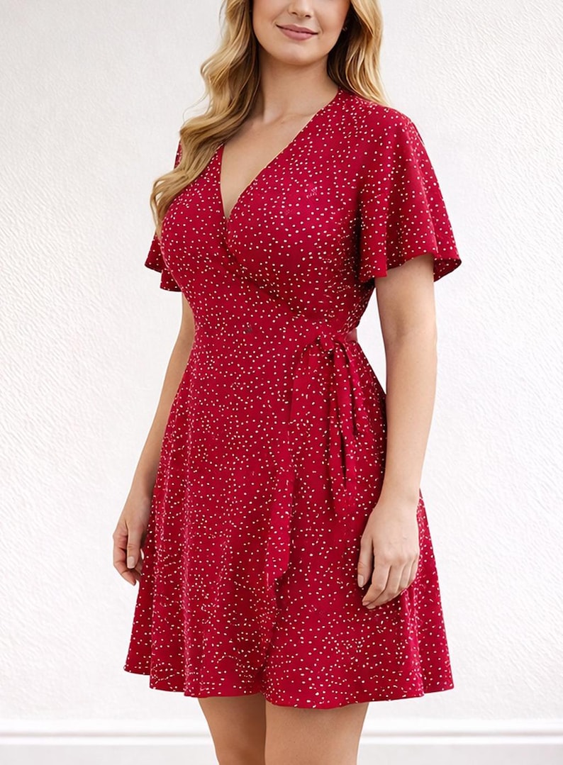 Side view of woman wearing a red floral Ruffle Hem Wrap Mini Dress on a plain background.