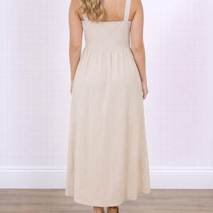 Back view of woman wearing a beige Long Dress on a white background.