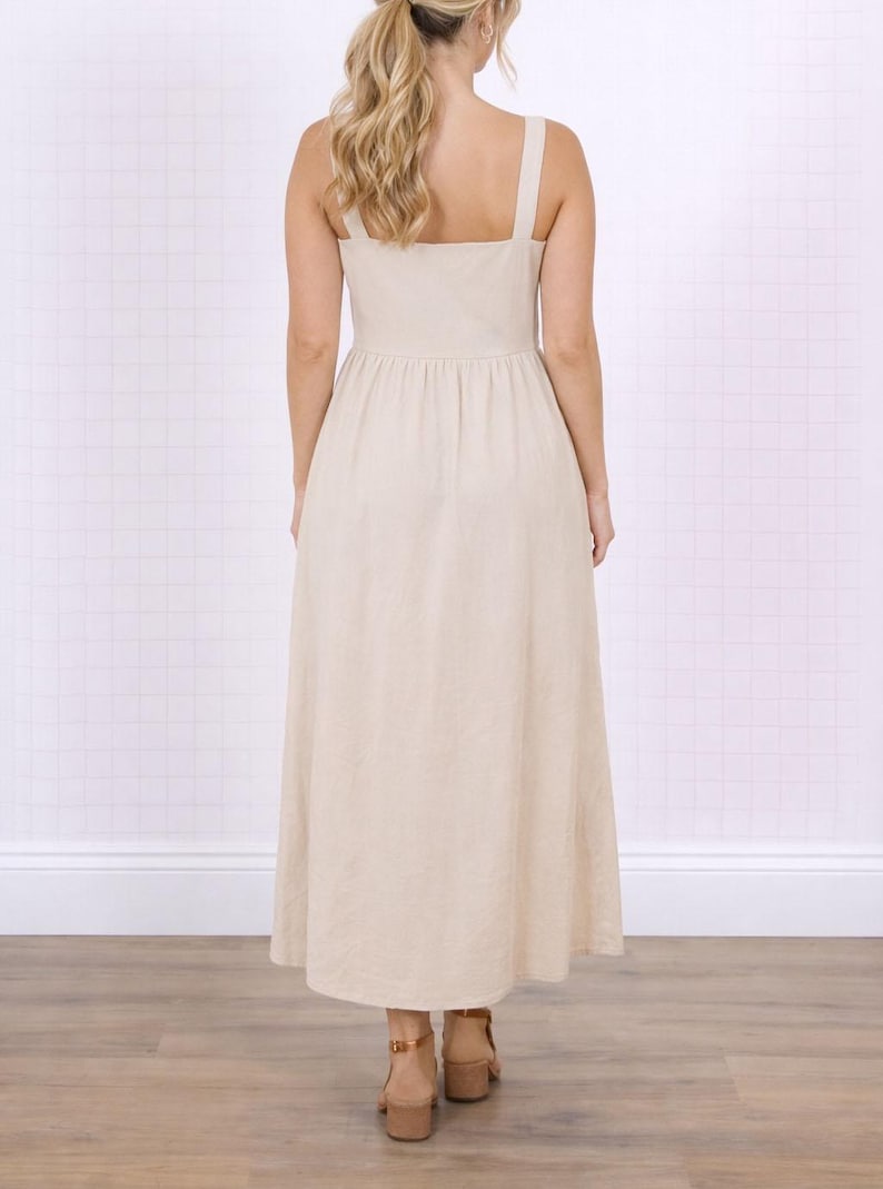 Back view of woman wearing a beige Long Dress on a white background.