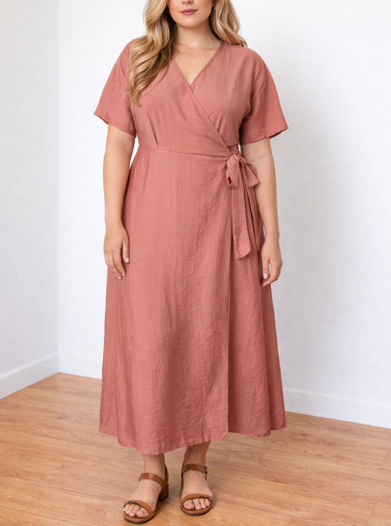 Woman wearing a pink Plus Size Kimono Sleeve Wrap Maxi Dress with a white background.